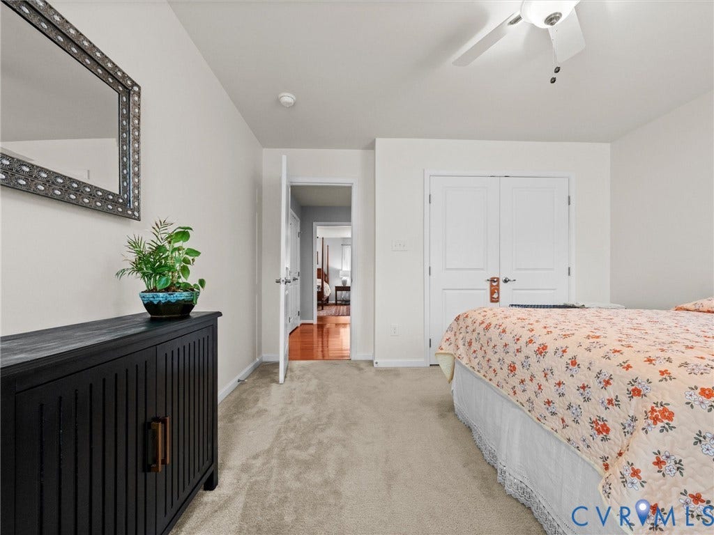 9990 Orchard Meadow Road, Mechanicsville, VA 23116 Neutral-toned wall paint with a white ceiling fan and light fixture