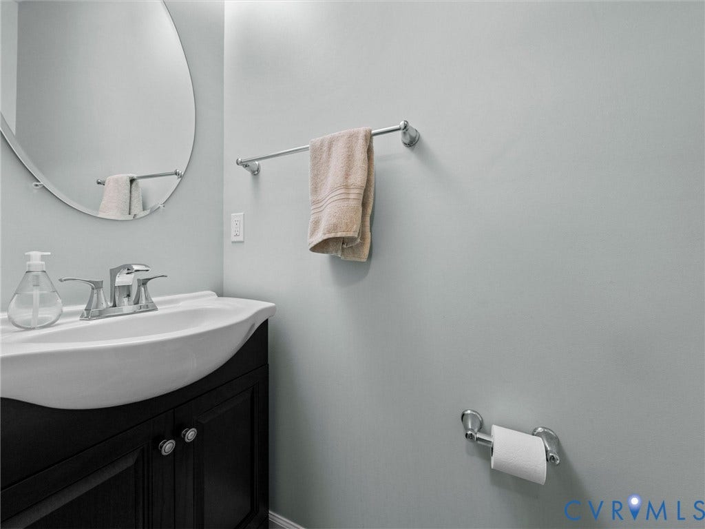 9990 Orchard Meadow Road, Mechanicsville, VA 23116 Wall-mounted vanity with a white basin and chrome faucet