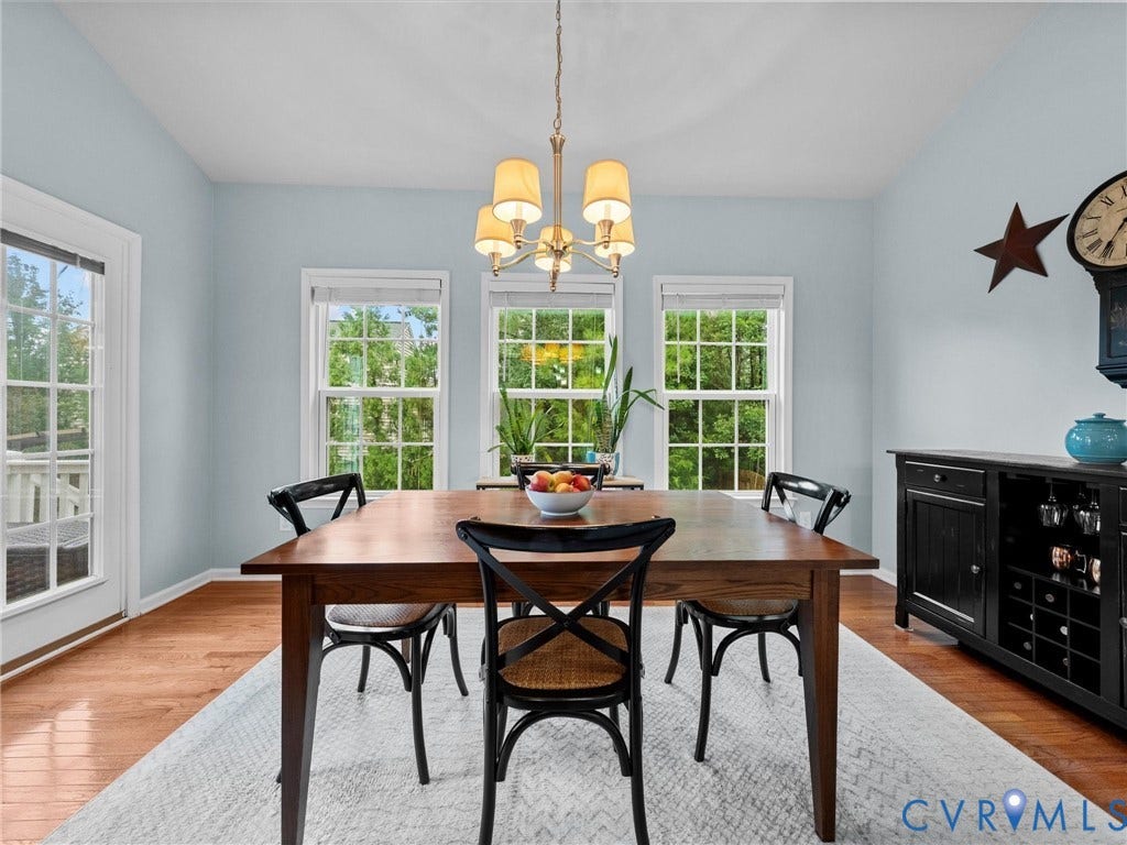 9990 Orchard Meadow Road, Mechanicsville, VA 23116 Wood-finish flooring, multiple windows, a chandelier light fixture, and a built-in wine rack with cabinetry