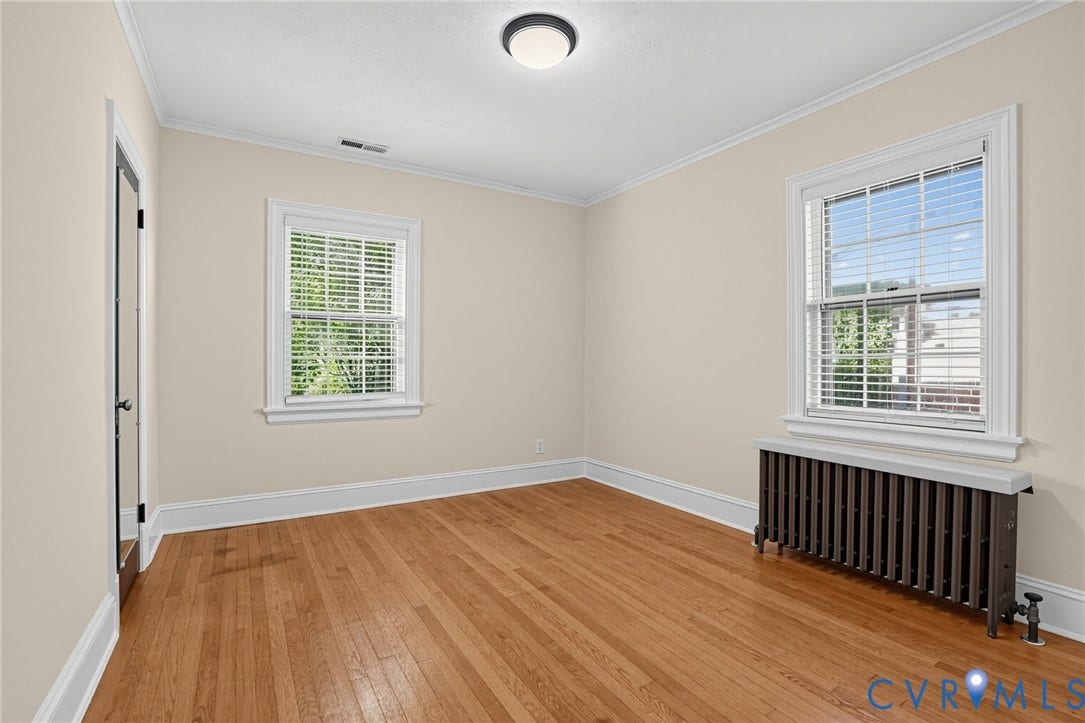 1713 Wilmington Avenue, Richmond, VA 23227 Wood-finish flooring, crown molding, and two windows with blinds