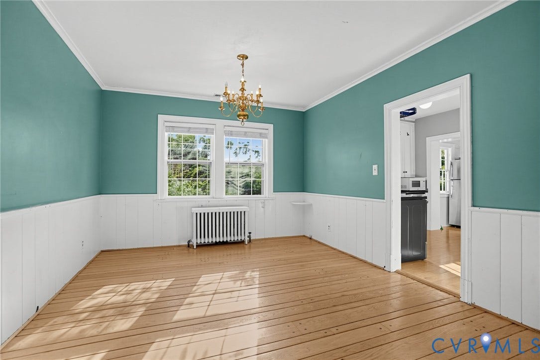 1713 Wilmington Avenue, Richmond, VA 23227 Hardwood flooring, two large windows, a brass chandelier, and white wainscoting