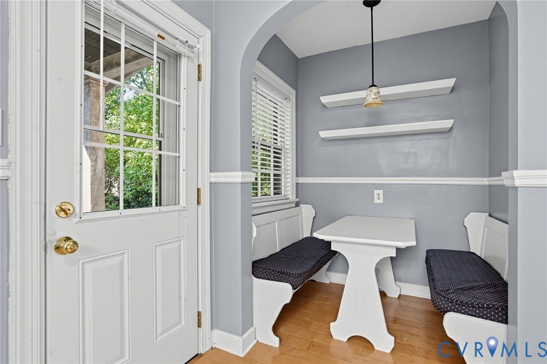 1713 Wilmington Avenue, Richmond, VA 23227 Arched entryway leading to a breakfast nook with built-in bench seating, wood-finish flooring, and a window with blinds
