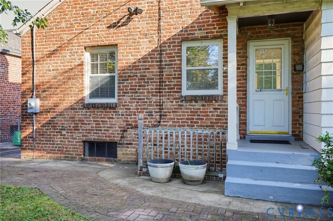1713 Wilmington Avenue, Richmond, VA 23227 Brick exterior with white window trim and a light-colored entry door