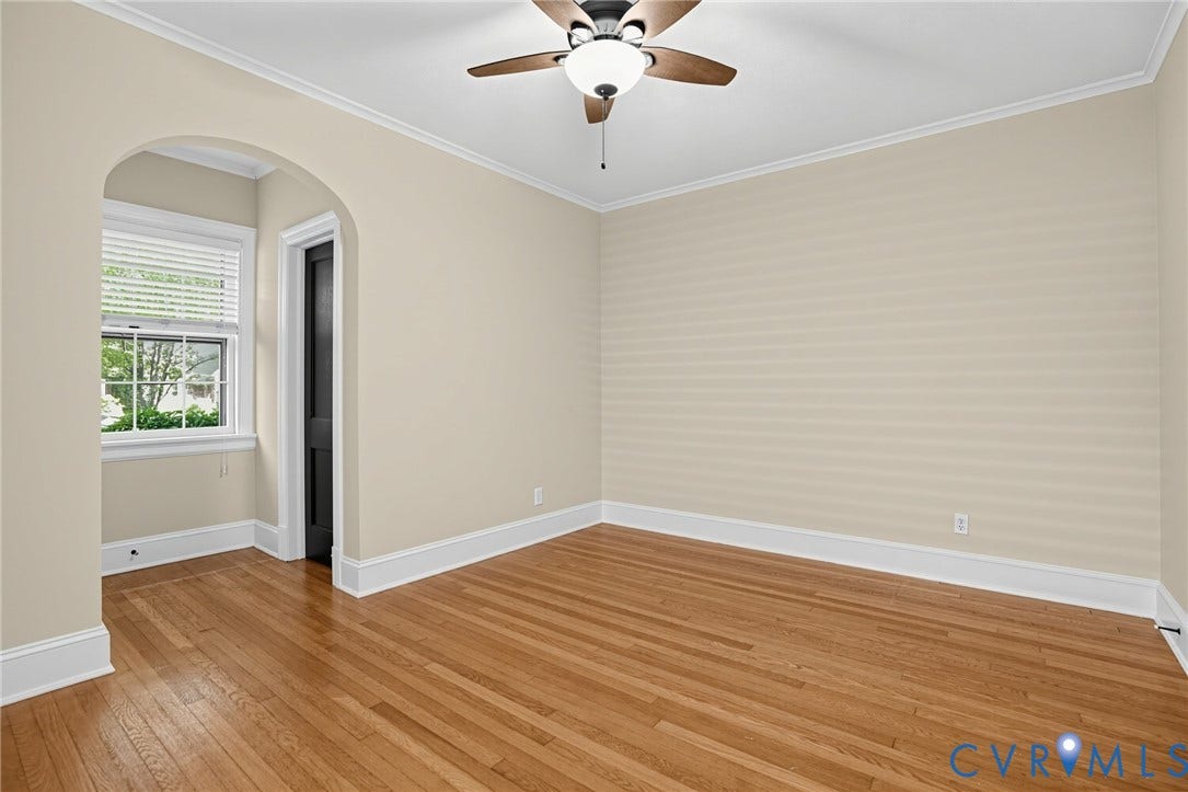 1713 Wilmington Avenue, Richmond, VA 23227 Hardwood flooring, arched doorway, ceiling fan with light fixture, window with blinds, and white trim