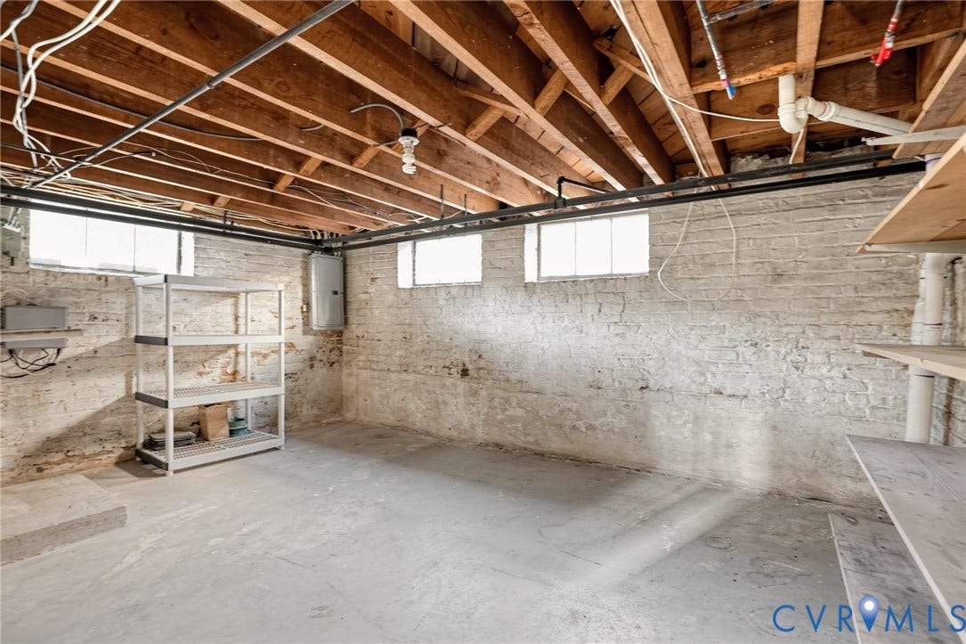 1713 Wilmington Avenue, Richmond, VA 23227 Exposed wooden ceiling joists, concrete flooring, and painted brick walls