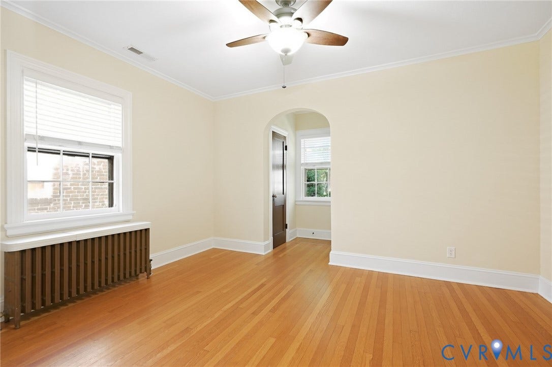 1713 Wilmington Avenue, Richmond, VA 23227 Hardwood flooring, arched doorway, ceiling fan with light fixture, crown molding, and window with blinds