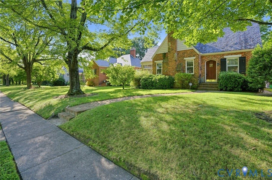 1713 Wilmington Avenue, Richmond, VA 23227 Brick exterior featuring a gabled roof and mature landscaping