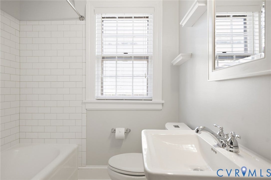 1713 Wilmington Avenue, Richmond, VA 23227 White subway tile shower surround with a built-in tub