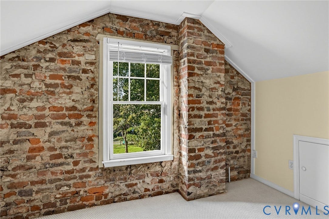 1713 Wilmington Avenue, Richmond, VA 23227 Exposed brick walls, white trim window with multiple panes, white sloped ceiling, light-colored carpeting, and white access door
