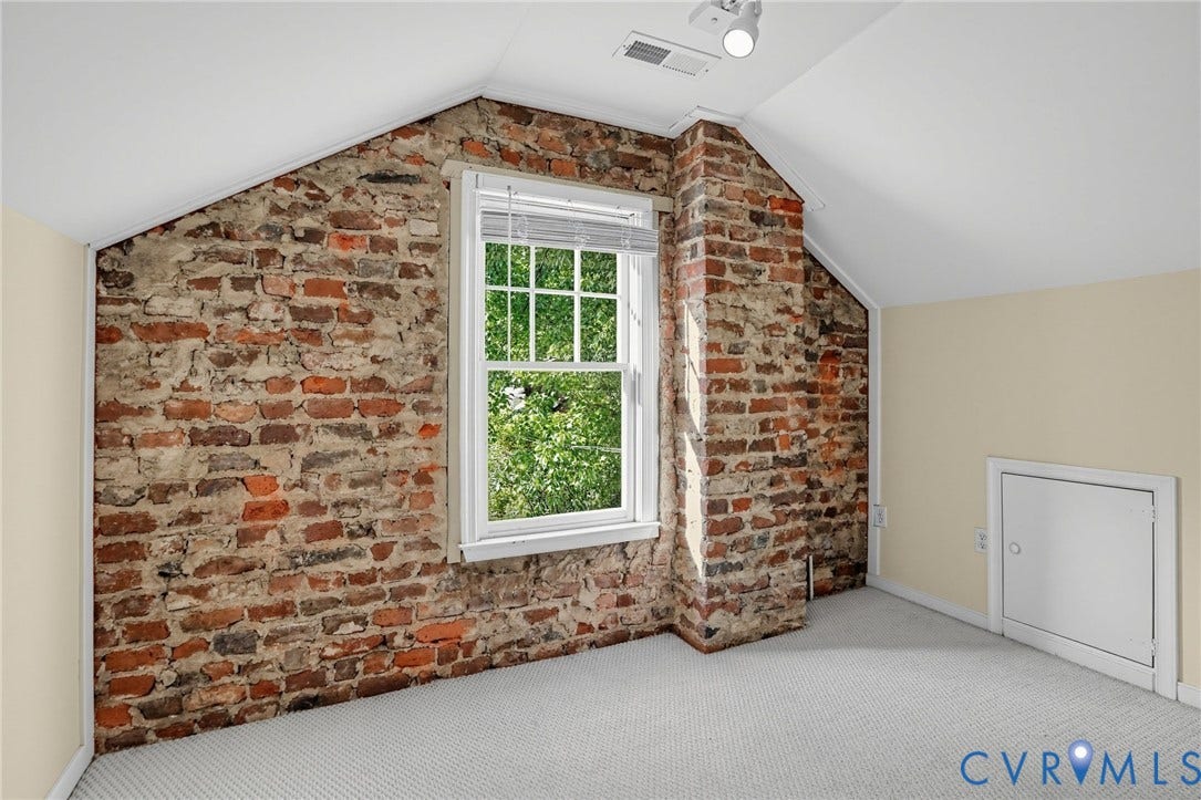 1713 Wilmington Avenue, Richmond, VA 23227 Exposed brick wall with a built-in window and integrated chimney