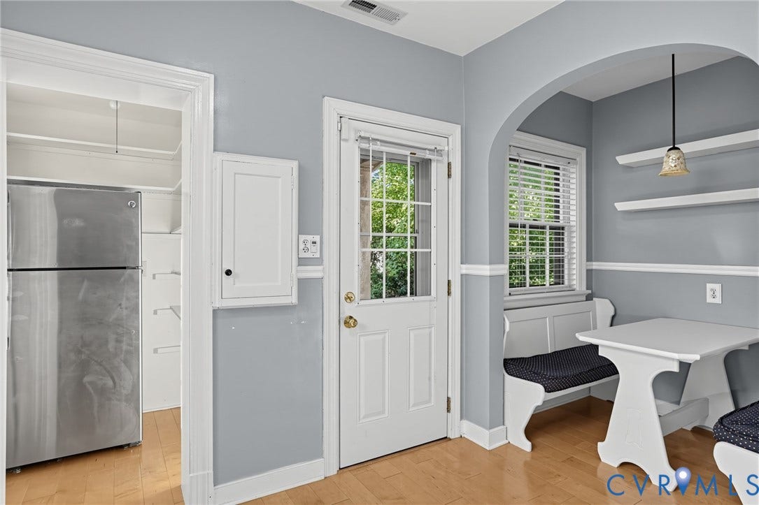 1713 Wilmington Avenue, Richmond, VA 23227 Wood-finish flooring, built-in shelving, white trim, and a glass-paneled door