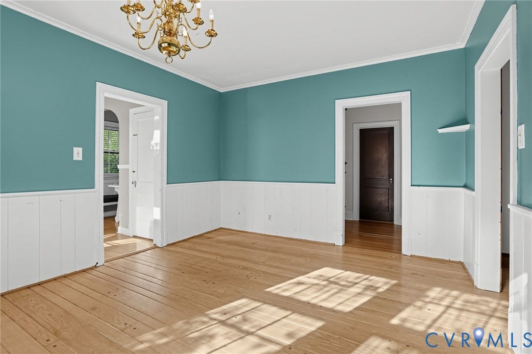 1713 Wilmington Avenue, Richmond, VA 23227 Hardwood flooring, crown molding, wainscoting, brass chandelier, and multiple doorways
