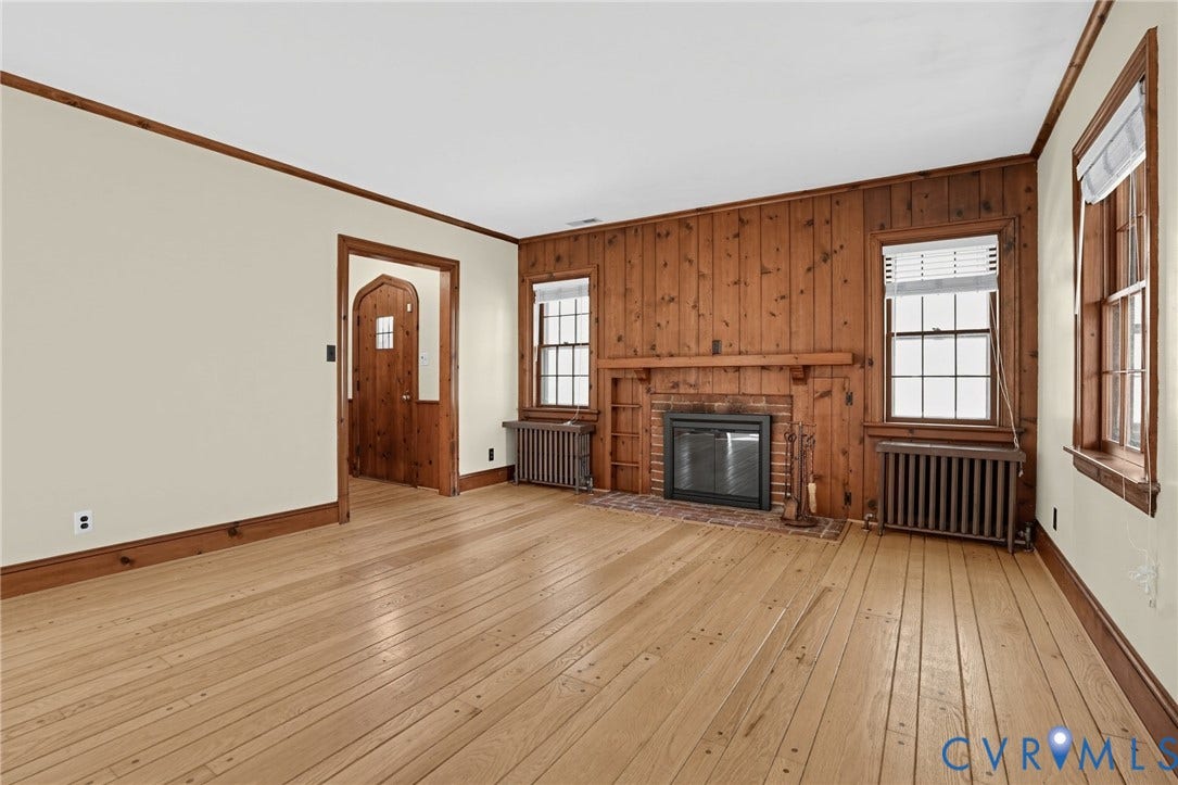 1713 Wilmington Avenue, Richmond, VA 23227 Wood-paneled wall with a brick-surround fireplace