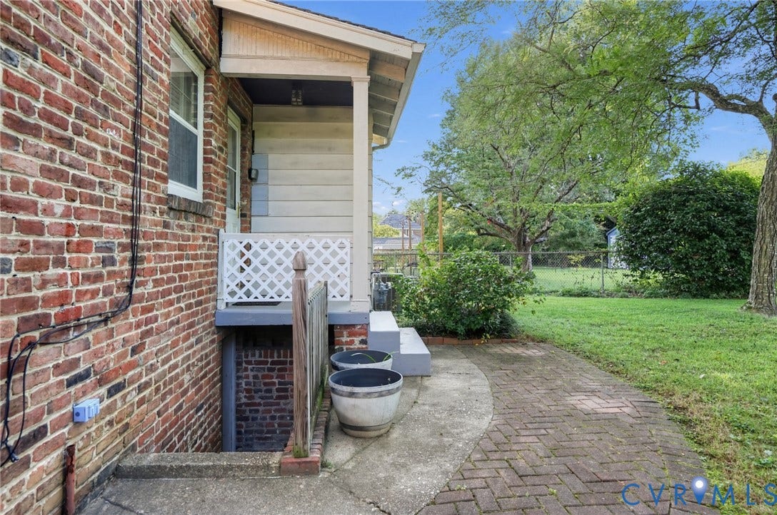 1713 Wilmington Avenue, Richmond, VA 23227 Brick exterior with white window trim and a covered side entrance
