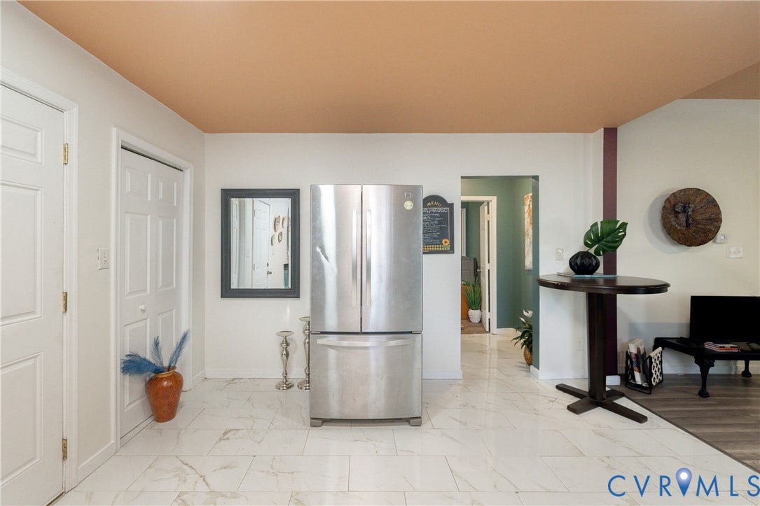 2127 Wright Avenue, Bellemeade, Richmond, VA 23224 White paneled interior doors, stainless steel refrigerator, white tile flooring, wood-finish flooring, and a unique two-tone ceiling