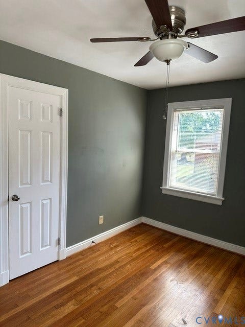 3311 Lanceor Drive, Henrico, VA 23060 Wood-finish flooring with white trim, a multi-panel door, and a ceiling fan with integrated lighting