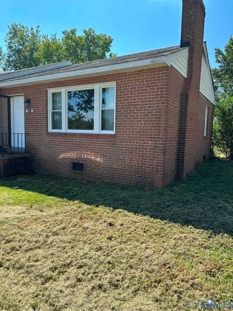 3311 Lanceor Drive, Henrico, VA 23060 Brick exterior with white trim, a prominent brick chimney, and multi-pane windows