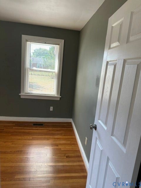 3311 Lanceor Drive, Henrico, VA 23060 Hardwood flooring, painted walls, white trim, and a paneled door