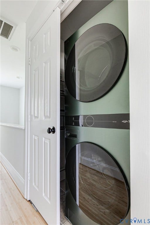 1311 N 33rd Street, Oakwood, Richmond, VA 23223 Stackable laundry appliances within a dedicated closet, featuring a paneled door with matte black hardware