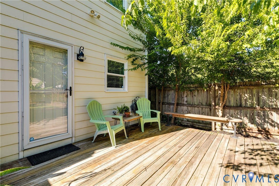 1311 N 33rd Street, Oakwood, Richmond, VA 23223 Expansive wooden deck with a privacy fence, mature trees, and exterior lighting