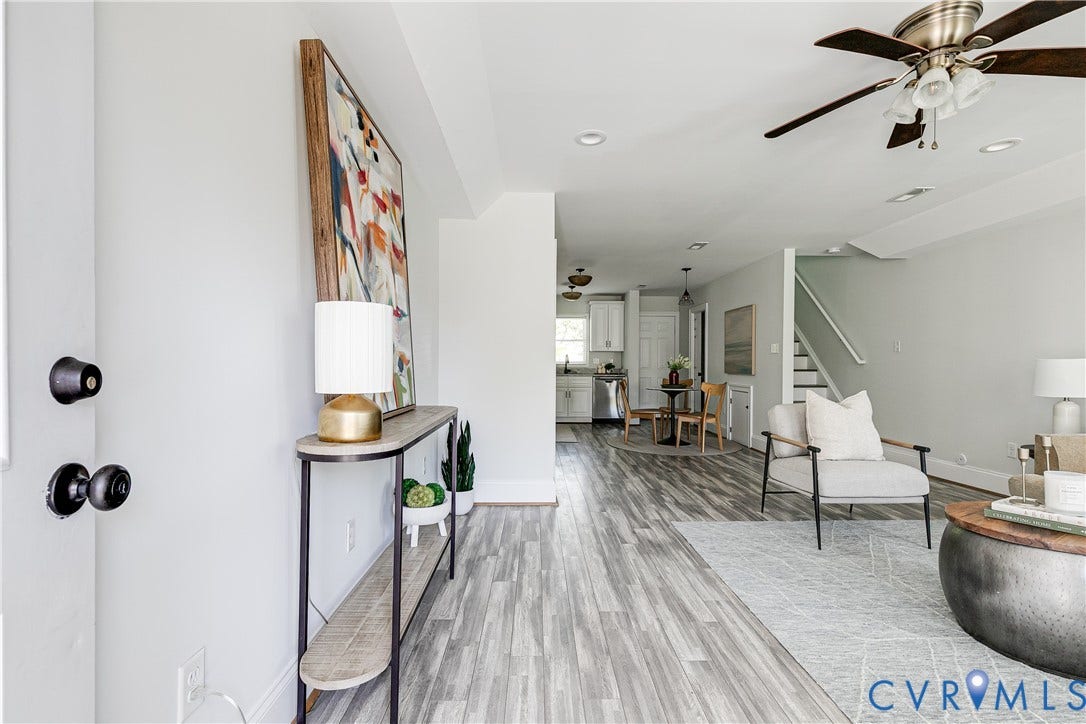 1311 N 33rd Street, Oakwood, Richmond, VA 23223 Wood-finish flooring throughout, recessed lighting, ceiling fan, white wall paint, and white staircase with wood-finish handrail