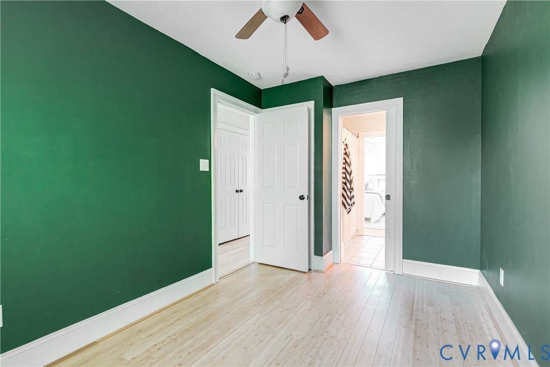 1311 N 33rd Street, Oakwood, Richmond, VA 23223 Room featuring wood-finish flooring, a ceiling fan with wood-tone blades, and white trim