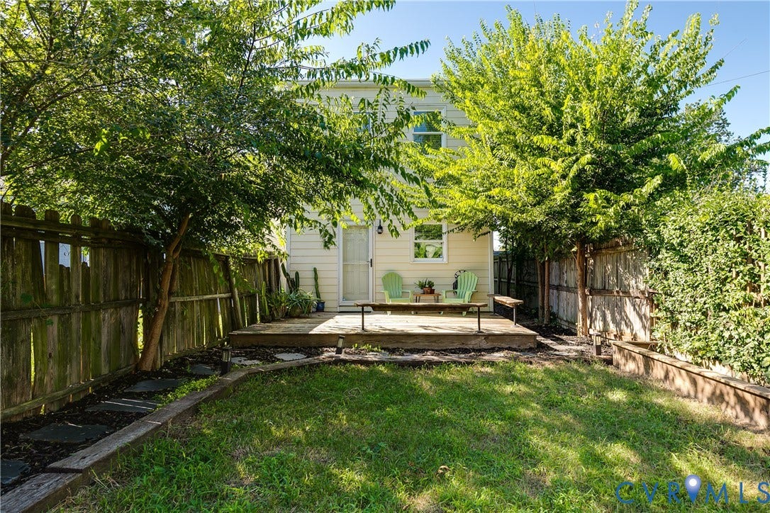1311 N 33rd Street, Oakwood, Richmond, VA 23223 Expansive backyard featuring a wood deck, wood privacy fencing, and mature trees