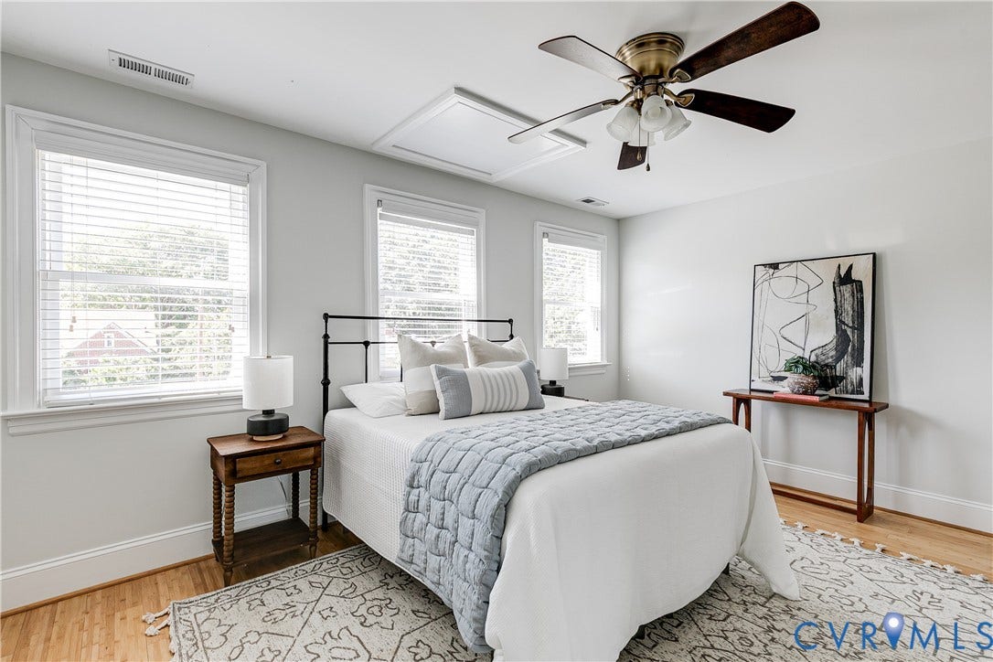 1311 N 33rd Street, Oakwood, Richmond, VA 23223 Bright room with wood-finish flooring, multiple windows with blinds, a ceiling fan, and white walls