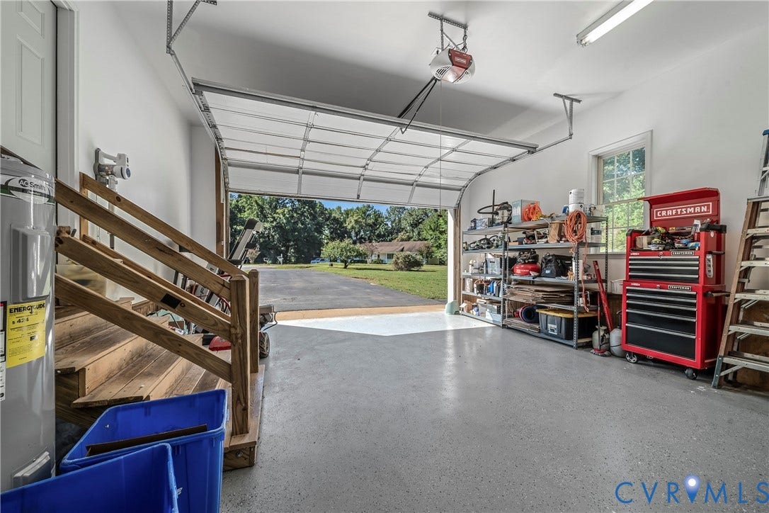 1206 Archie Lane, Osborne Heights / Varina, Henrico, VA 23231 Two-car garage with epoxy-coated flooring, built-in shelving, and a bright window