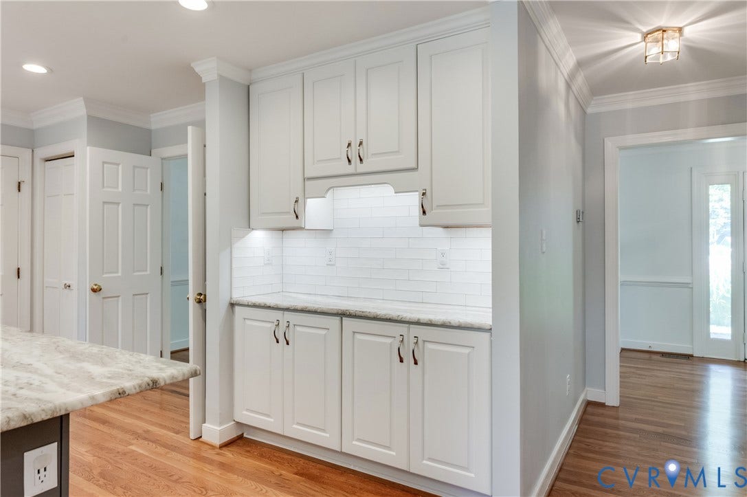 11211 Warren View Road, Henrico, VA 23233 Built-in cabinetry with white shaker-style doors, white subway tile backsplash, and stone countertops