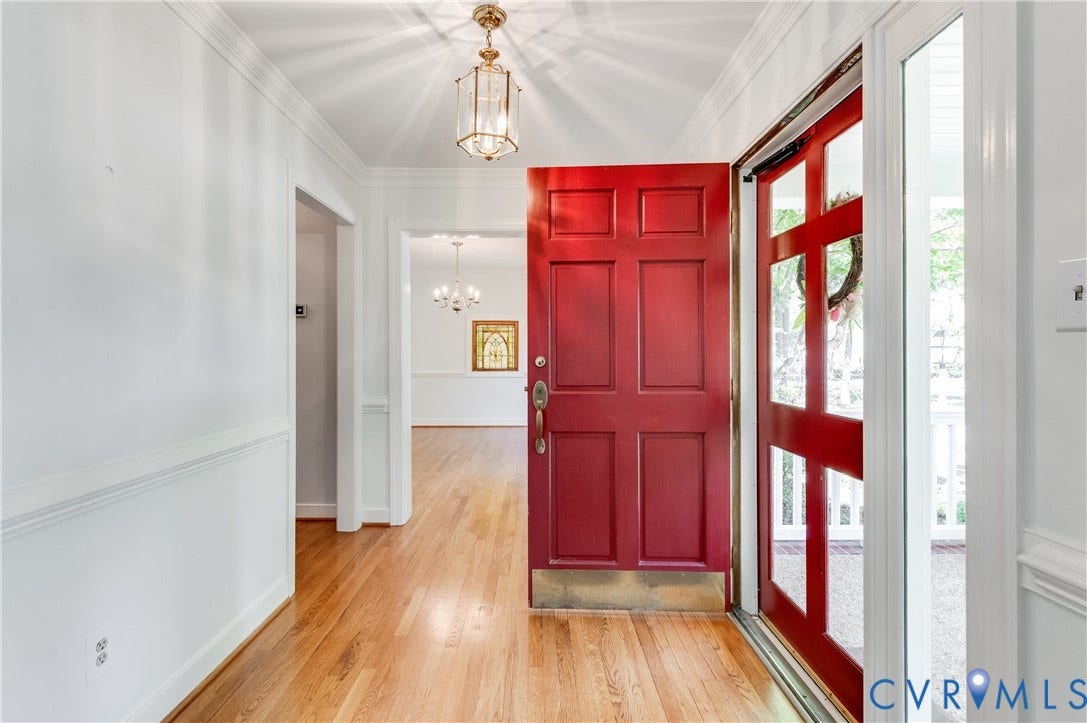 11211 Warren View Road, Henrico, VA 23233 Entryway featuring a red paneled door, wood-finish flooring, and a decorative pendant light