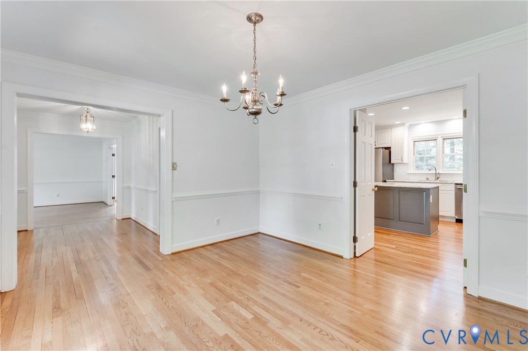 11211 Warren View Road, Henrico, VA 23233 Hardwood flooring throughout, crown molding, chair rail molding, and a chandelier in the dining space