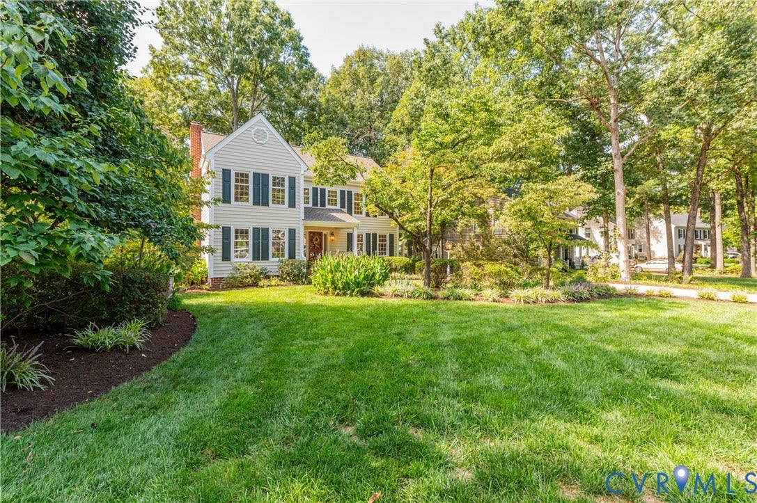 11211 Warren View Road, Henrico, VA 23233 Two-story residence with light-colored siding, dark shutters, and a prominent chimney