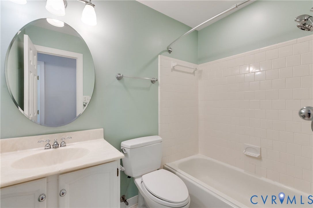 11211 Warren View Road, Henrico, VA 23233 Vanity with integrated sink, chrome hardware, and an oval mirror