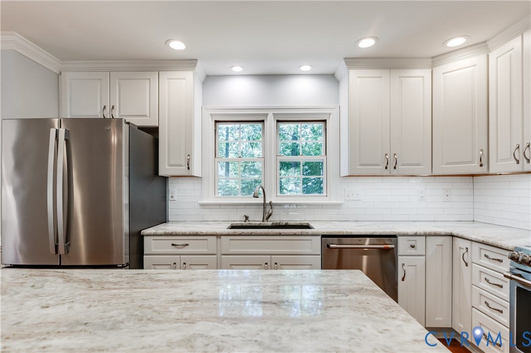 11211 Warren View Road, Henrico, VA 23233 Updated kitchen featuring white shaker cabinetry, stainless steel appliances, white subway tile backsplash, and light-toned stone countertops
