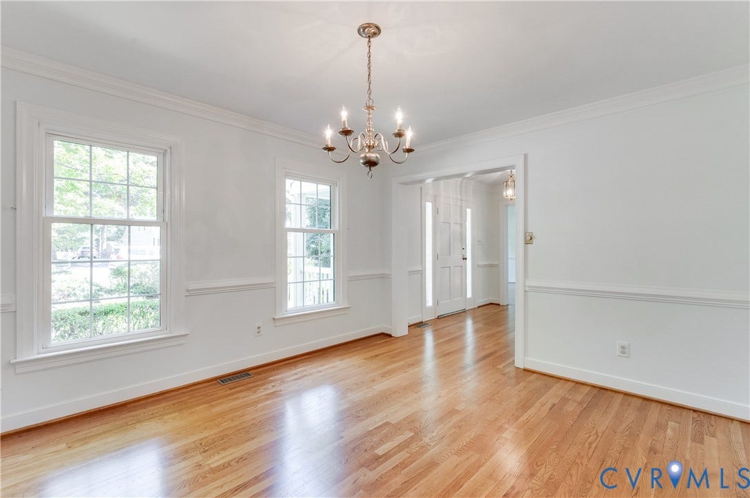 11211 Warren View Road, Henrico, VA 23233 Hardwood flooring, crown molding, chair rail molding, two large windows, and a classic chandelier