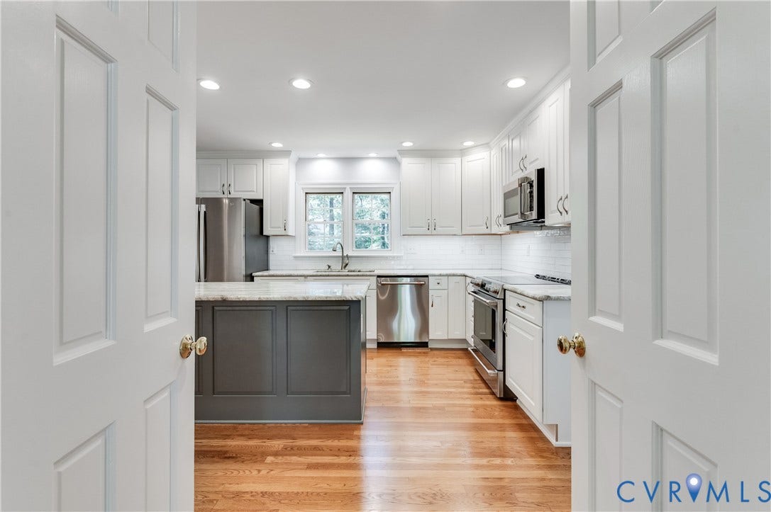11211 Warren View Road, Henrico, VA 23233 Renovated kitchen featuring a central island with a stone countertop, white shaker cabinetry, stainless steel appliances, wood-finish flooring, and recessed lighting