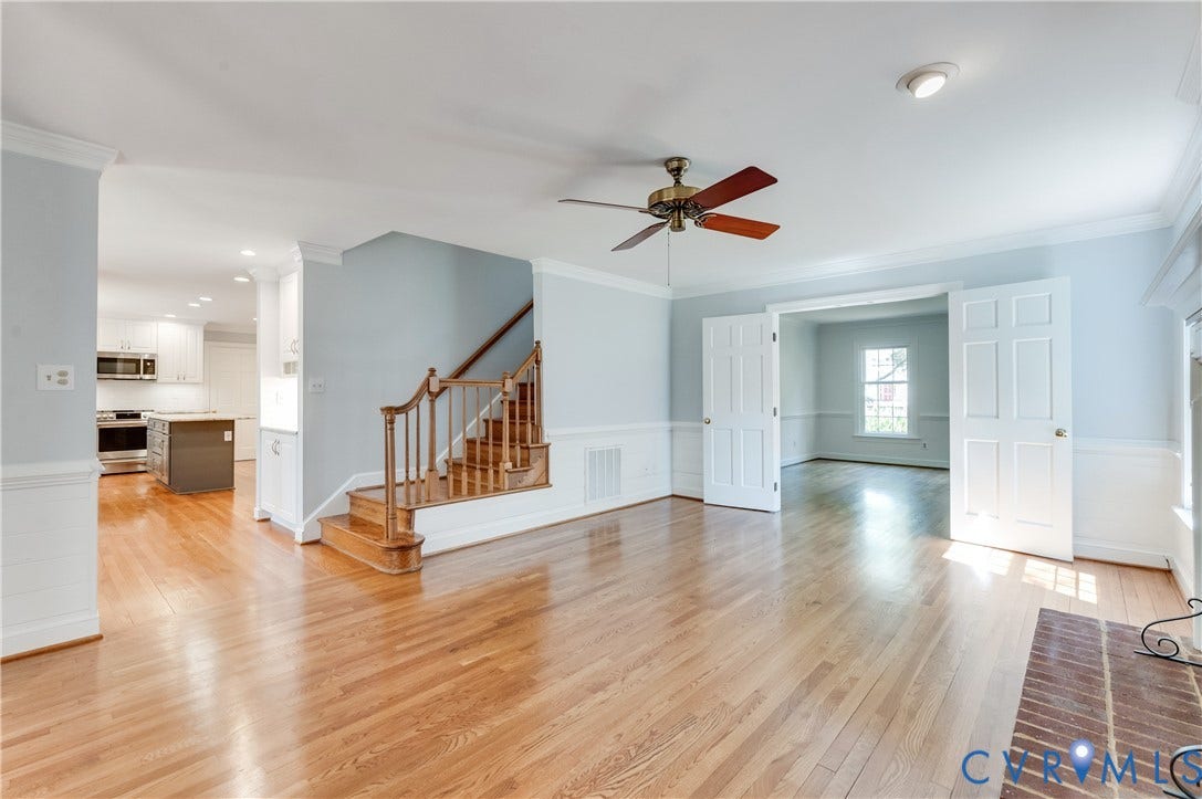 11211 Warren View Road, Henrico, VA 23233 Hardwood flooring throughout, a traditional wooden staircase, white paneled doors, and a ceiling fan