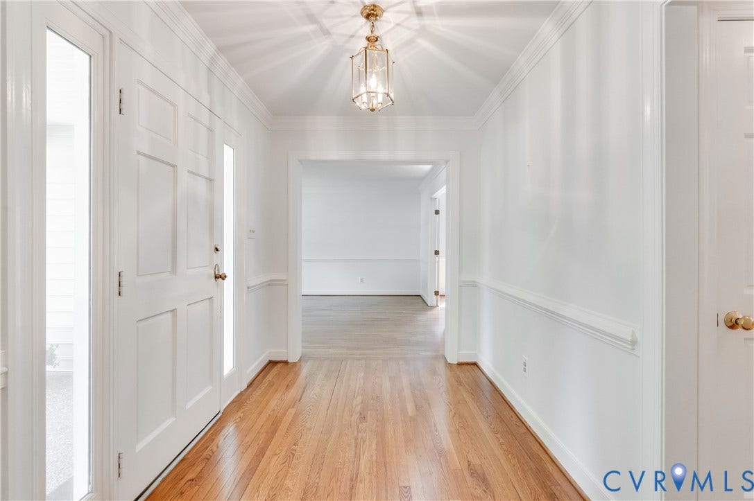 11211 Warren View Road, Henrico, VA 23233 Entryway with wood-finish flooring, paneled front door, sidelight windows, and decorative chandelier