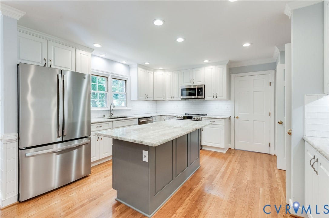11211 Warren View Road, Henrico, VA 23233 Kitchen featuring light wood-finish flooring, white cabinetry, a center island with a light-toned countertop, stainless steel appliances, and recessed lighting