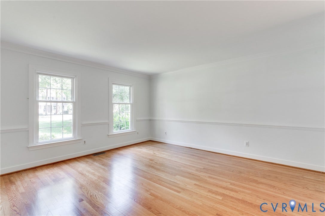 11211 Warren View Road, Henrico, VA 23233 Hardwood flooring, white painted walls, two double-hung windows, chair rail molding, and crown molding