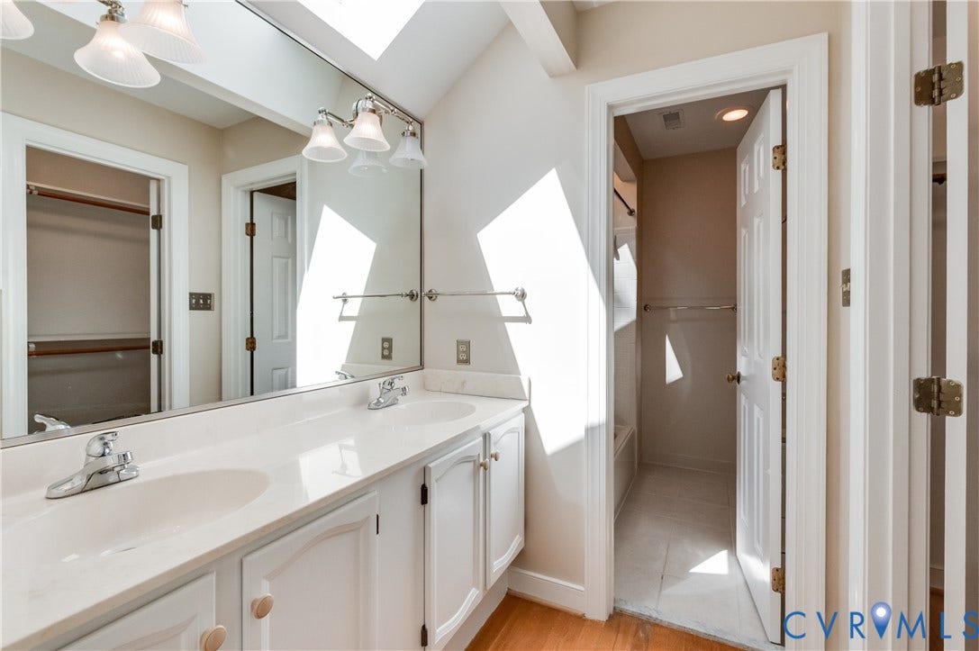 11211 Warren View Road, Henrico, VA 23233 Dual vanity with undermount sinks, expansive wall-mounted mirror, and overhead lighting fixtures