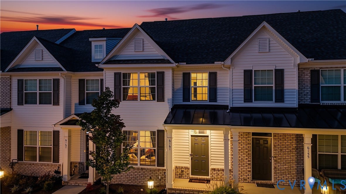 White siding exterior with brick accents