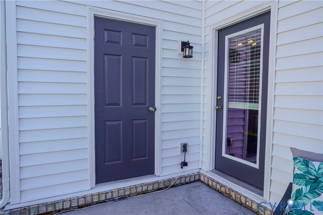 White horizontal siding with contrasting dark panel and glass-panel doors