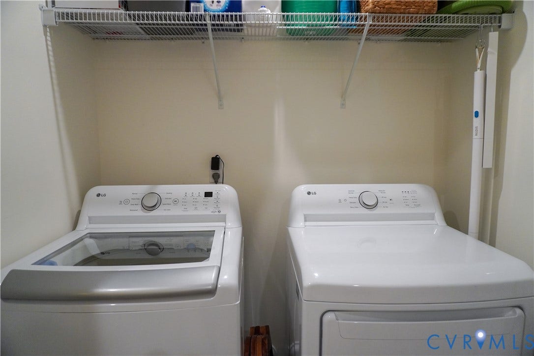 Laundry area featuring white appliances, a top-loading washer, a front-loading dryer, and an overhead wire shelf