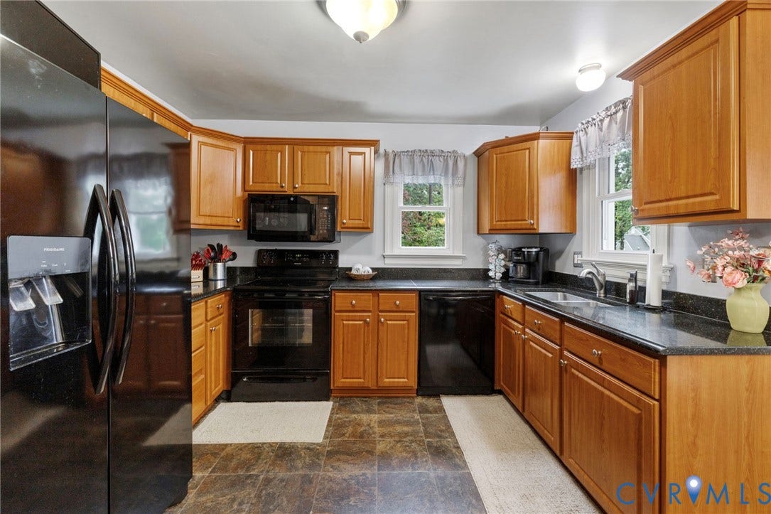 11805 Bedfordshire Square, Henrico, VA 23238 Kitchen featuring wood cabinetry, granite countertops, built-in black appliances, door to side yard