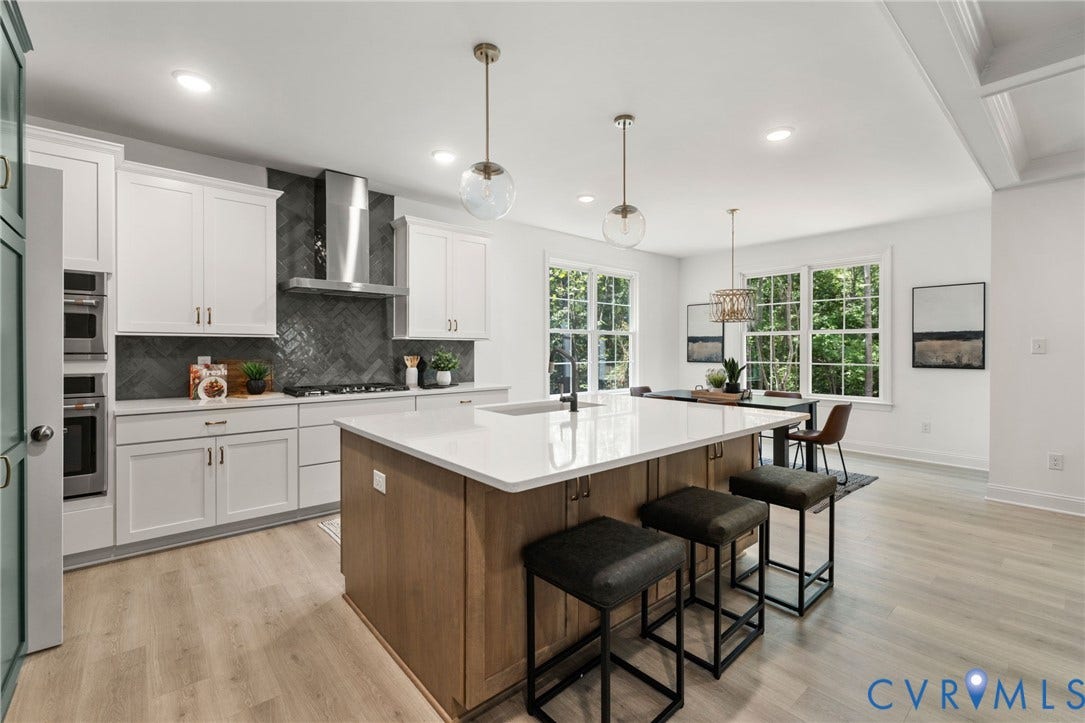 12506 Ashton Dell Road, Chester, VA 23831 Gourmet kitchen with white cabinetry, built-in double ovens, and a large central island