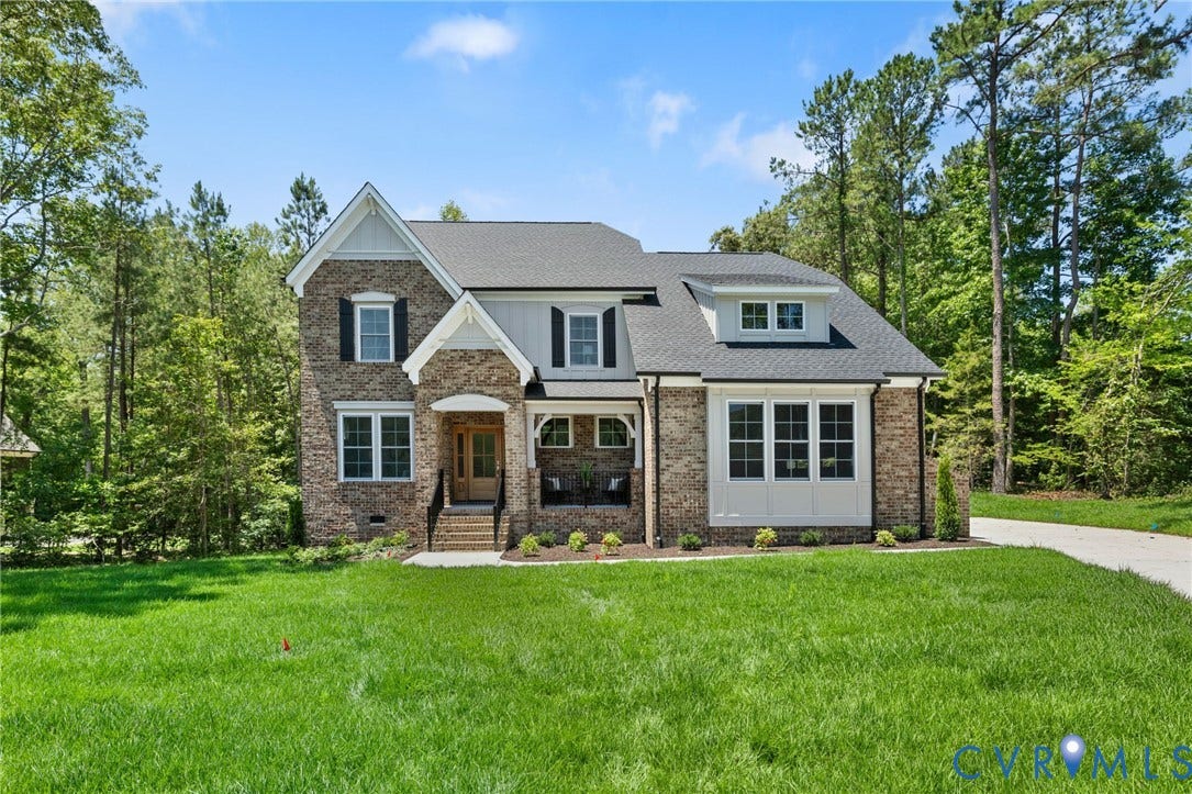 12506 Ashton Dell Road, Chester, VA 23831 Stone and siding exterior with dark-framed windows, a covered front porch, and a dormer window