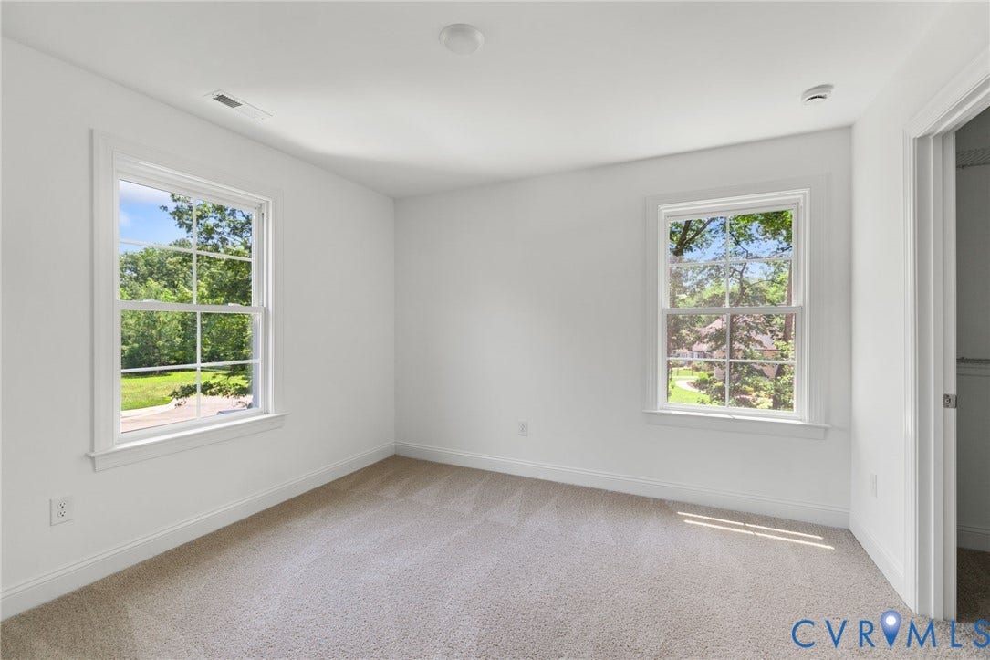 12506 Ashton Dell Road, Chester, VA 23831 White walls with carpeting, two double-hung windows, and a flush-mount ceiling light