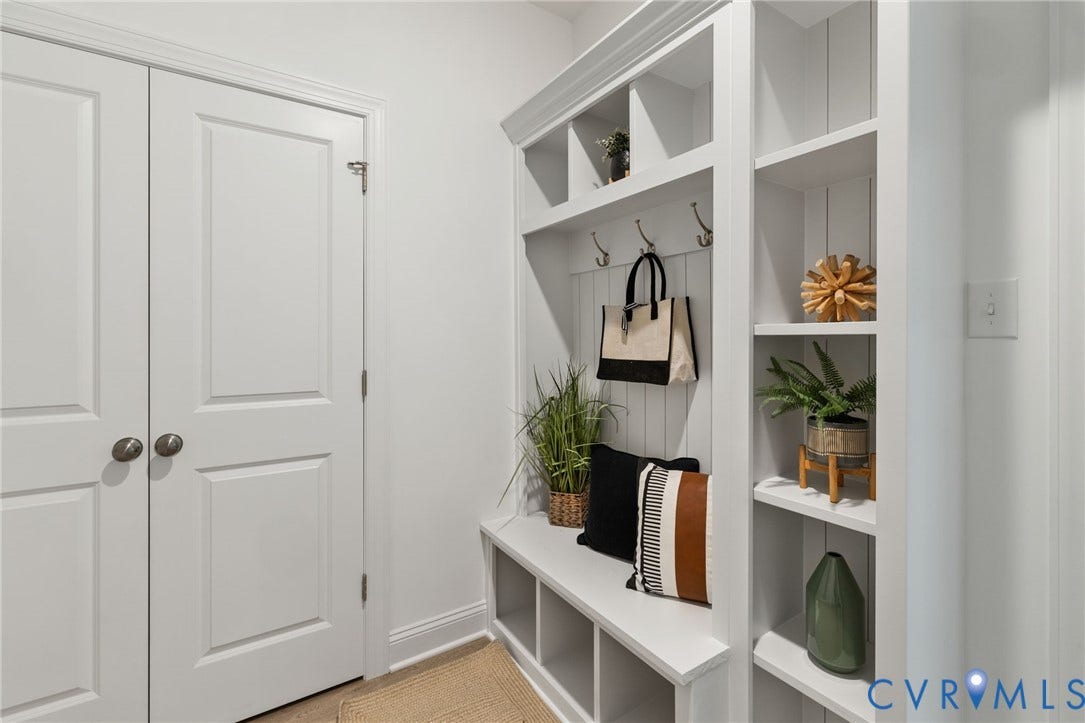 12506 Ashton Dell Road, Chester, VA 23831 Built-in storage bench with cubbies, white wall paneling, integrated coat hooks, and open shelving